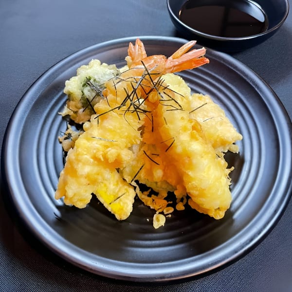 Crispy Boru Ramen tempura shrimp and vegetables, garnished with nori strips, served with a side of dipping sauce.